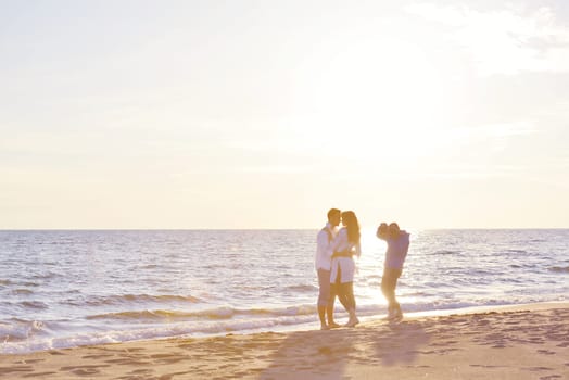 happy young romantic couple in love have fun on beautiful beach at beautiful summer day