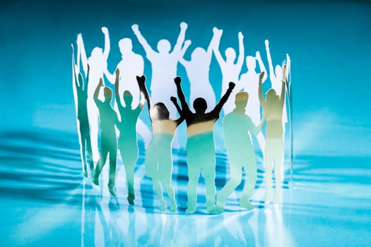 Silhouettes of exited people standing in circle