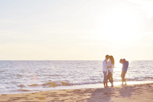 happy young romantic couple in love have fun on beautiful beach at beautiful summer day