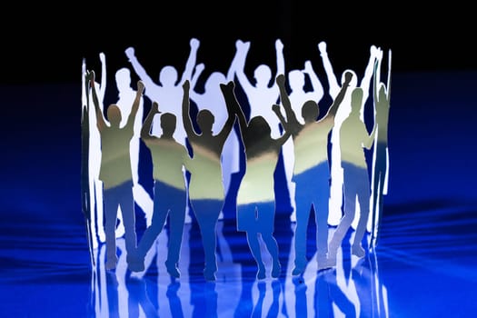 Silhouettes of exited people standing in circle