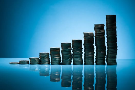 Stack Of One Euro Coins Over Blue Background