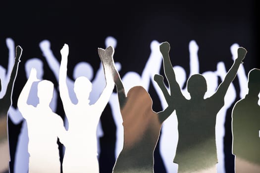 Silhouettes of exited people standing in circle