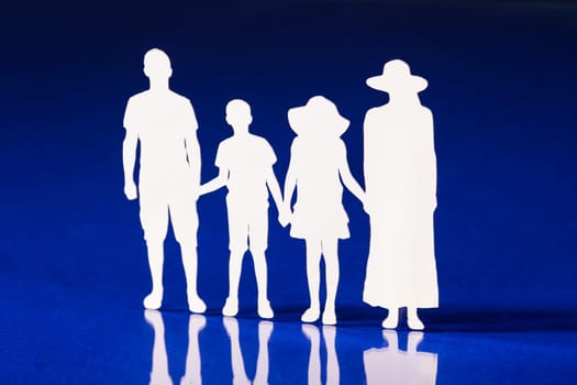 Silhouettes of family members holding hands together