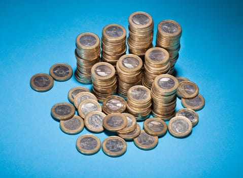 Stack Of Golden Coin Over Blue Background