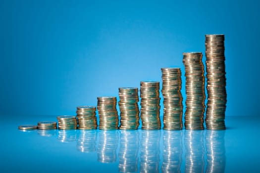 Stack Of One Euro Coins Over Blue Background