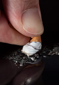 Extreme Close-up Of Hand Crushing A Cigarette