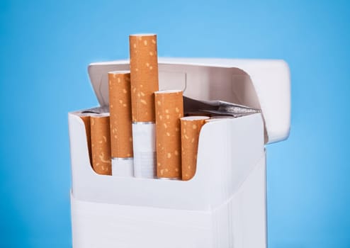Photo Of Cigarettes In Pack Over Blue Background