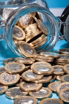 Euro Coins Spilling From A Money Jar