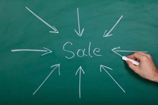 Hand Drawn Arrows Gathering Over Sale On Chalkboard
