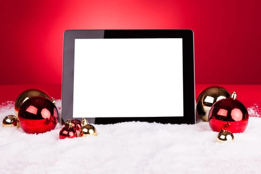 Blank Digital Tablet With Christmas Baubles On Red Background