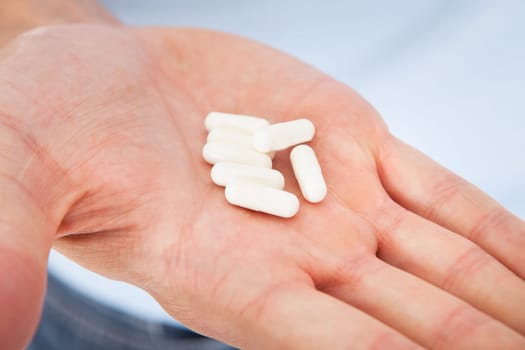Capsule Held On Palm Of A Person