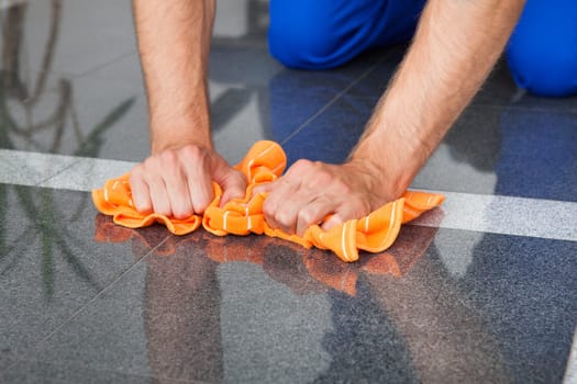 Young Man Cleaning The Dust On Floor With Duster