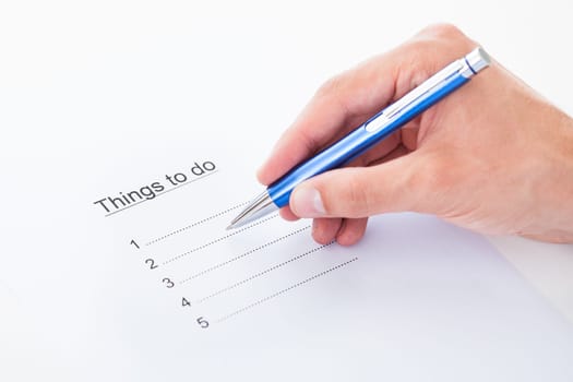 Closeup on hand filling things to do list