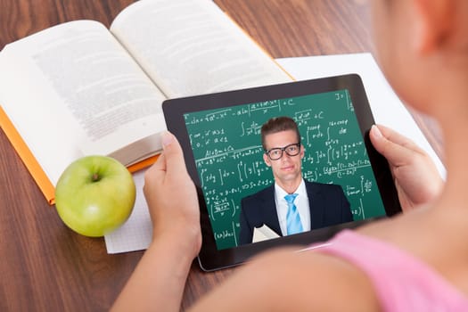 Female student watching education tutorials on digital tablet