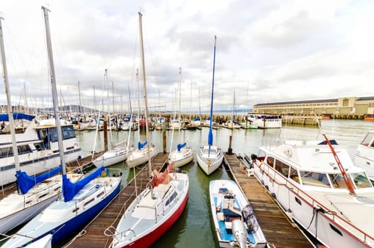 The Pier 39 Marina at Fisherman's wharf, Embarcadero, San Francisco, California, United States of America. A view of the boats, yachts, sailing vessels docked at the platform.