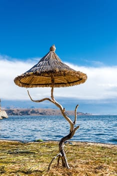 Small reed umbrella on a floating island on Lake Titicaca near Copacabana, Bolivia