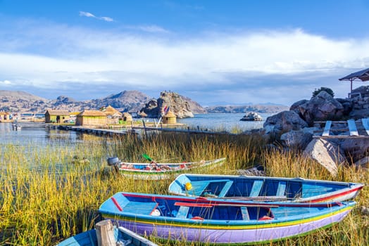Colorful boats near floating islands on Lake Titicaca near Copacabana, Bolivia