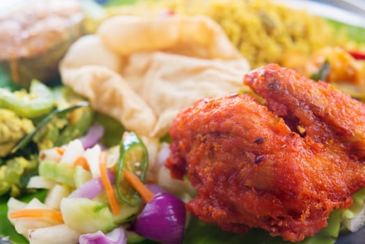 Close up Indian biryani rice with fried chicken.