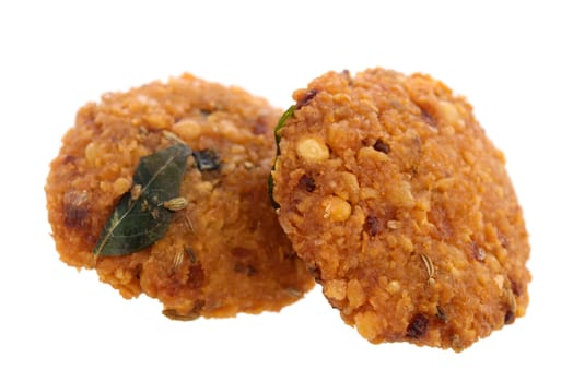 Crispy deep fired vadai snack, common street food in the Indian Subcontinent and Sri Lanka, shoot isolated on white background.