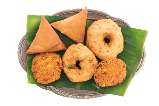 Delicious traditional Indian snack platter isolated on white background.