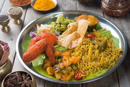 Traditional Indian biryani rice on wooden dining table.