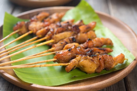 Close up Malaysian chicken satay on wooden dining table, one of famous local dishes.