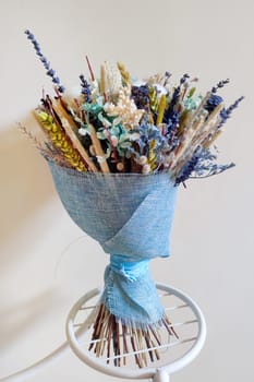 Bouquet of dried flowers on a light background close up