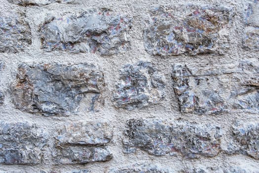 Close-up of a textured stone wall. An old house