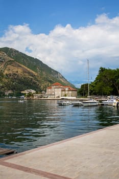 Very beautiful embankment of the Bay of Kotor, Montenegro. A beautiful and cozy city, tiled houses. The concept of rest and vacation in Europe