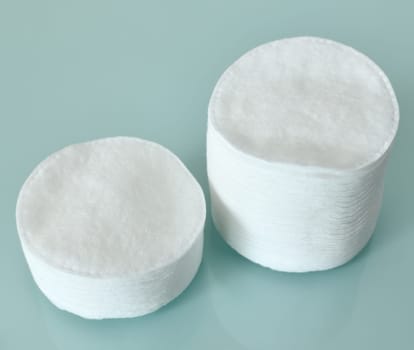 Stack of Cotton disks on a light blue background