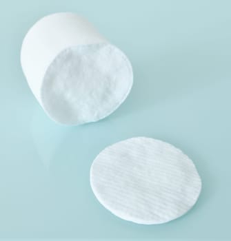 Stack of Cotton disks on a light blue background