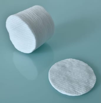 Stack of Cotton disks on a light blue background