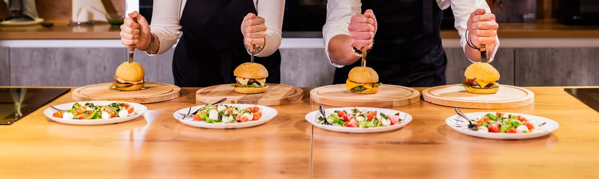 Beef burgers on wooden desk. Fat unhealthy food closeup