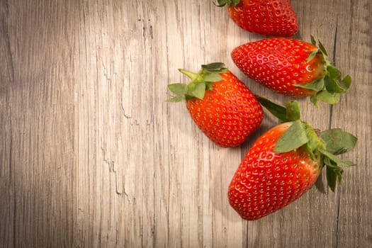 Strawberries on wooden background with text clearance
