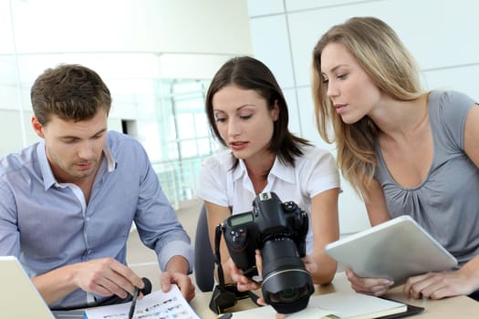 Team of photo reporters working in office