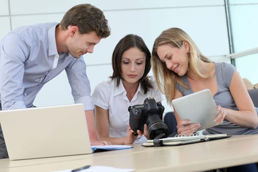 Team of photo reporters working in office