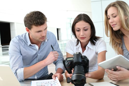 Team of photo reporters working in office