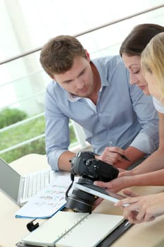 Team of photo reporters working in office