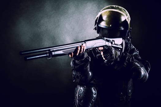 Spec ops soldier on black background with shotgun