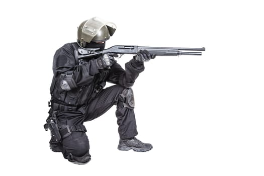 Spec ops soldier in black uniform and face mask with shotgun