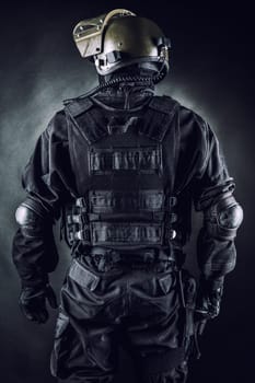 Spec ops soldier on black background shot from behind