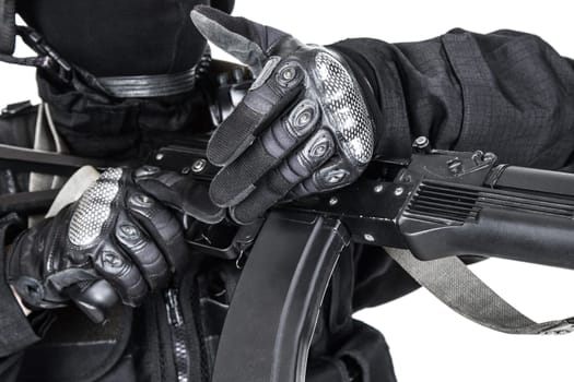 Spec ops soldier in black uniform and face mask with his rifle