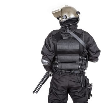 Spec ops soldier in black uniform and face mask shot from behind
