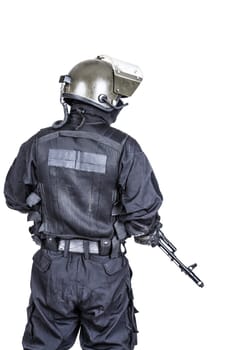 Spec ops soldier in black uniform and face mask shot from behind