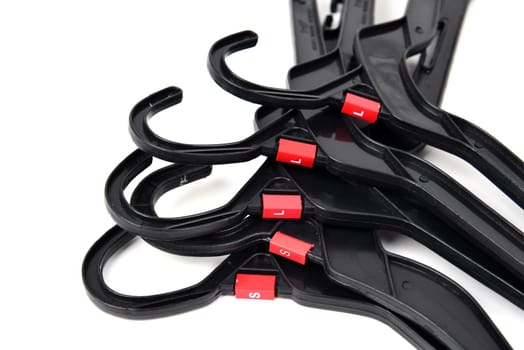 black plastic clothes hanger on white background