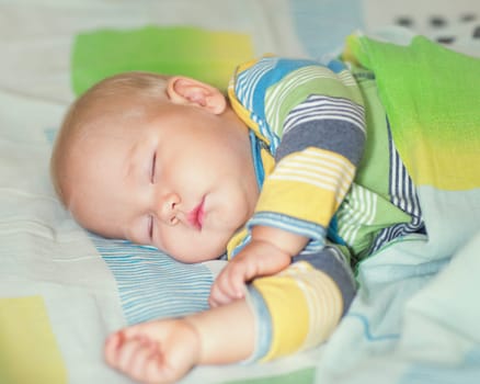 Cute baby is sleeping at home