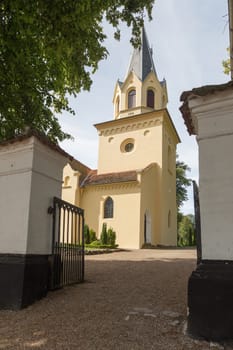Church photographed through the entrance gate to the cemetery
