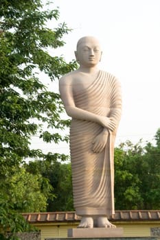Statue of disciple of Buddha standing in tranquil mood, Bodhgaya, Bihar, India, Asia