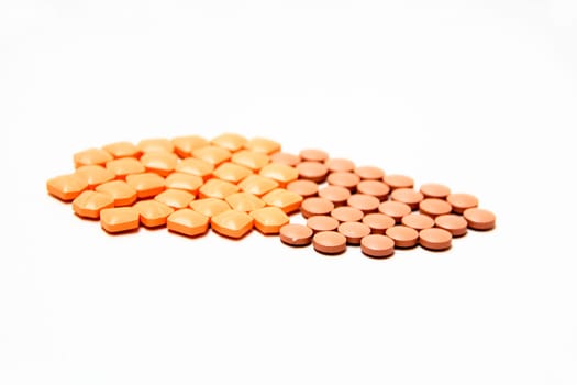 Pink and brown medicinal pills, isolated on white