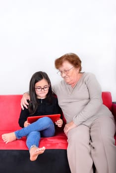 Happy grandmother and granddaughter using Tablet PC